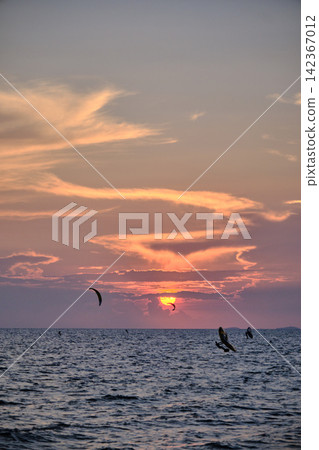 red twilight sky of sunset scene with cloudy sky over the open ocean with many waves red twilight sky of sunset scene with cloudy sky over the open ocean with many waves 142367012