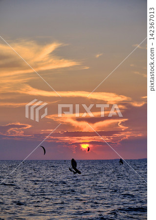 red twilight sky of sunset scene with cloudy sky over the open ocean with many waves red twilight sky of sunset scene with cloudy sky over the open ocean with many waves 142367013