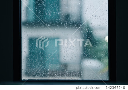 rain drops during raining in rainy day outside window glass with blurred background with water droplet flow down the surface rain drops during raining in rainy day outside window glass with blurred background with water droplet flow down the surface 142367248
