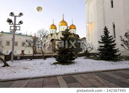 Assumption Cathedral (was the site of coronation of Russian tsars) at night, with the super moon. Cathedral Square, Inside of Moscow Kremlin, Russia. UNESCO World Heritage Site Assumption Cathedral (was the site of coronation of Russian tsars) at night, with the super moon. Cathedral Square, Inside of Moscow Kremlin, Russia. UNESCO World Heritage Site 142367495