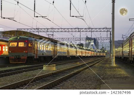 Train on Moscow passenger platform (Savelovsky railway station) with the super moon -- is one of the nine main railway stations in Moscow, Russia (at night) Train on Moscow passenger platform (Savelovsky railway station) with the super moon -- is one of the nine main railway stations in Moscow, Russia (at night) 142367496