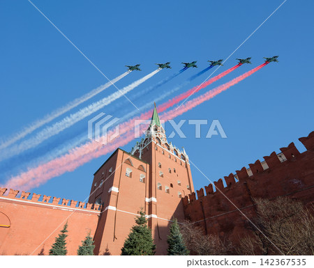 Moscow Kremlin, Russia -- Victory Day celebration (WWII), and Russian military aircraft with painted russian flag, Russia Moscow Kremlin, Russia -- Victory Day celebration (WWII), and Russian military aircraft with painted russian flag, Russia 142367535