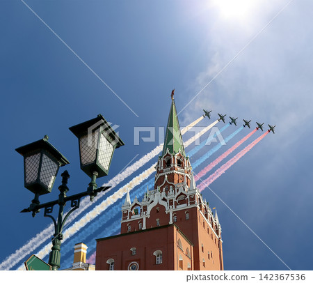 Moscow Kremlin, Russia -- Victory Day celebration (WWII), and Russian military aircraft with painted russian flag, Russia Moscow Kremlin, Russia -- Victory Day celebration (WWII), and Russian military aircraft with painted russian flag, Russia 142367536