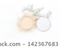 White powder spills from a round container. Skeletal coral rests beside the jar. Clean minimal scene on a bright surface. Ideal for beauty, skincare, or wellness themes 142367683