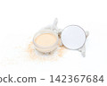 White powder spills from a round container. Skeletal coral rests beside the jar. Clean minimal scene on a bright surface. Ideal for beauty, skincare, or wellness themes 142367684