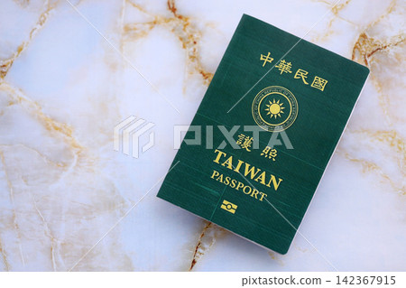 Taiwan passport on table close up. Official identification document book for citizens of Taiwan Taiwan passport on table close up. Official identification document book for citizens of Taiwan 142367915
