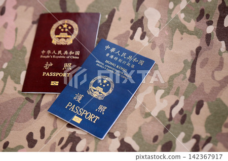 Chinese and Hong Kong passport on table. Official identification document book for citizens Chinese and Hong Kong passport on table. Official identification document book for citizens 142367917
