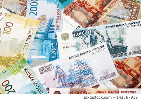 Russian ruble paper banknotes pile on table. Russia RUB currency money bills in big amount Russian ruble paper banknotes pile on table. Russia RUB currency money bills in big amount 142367919
