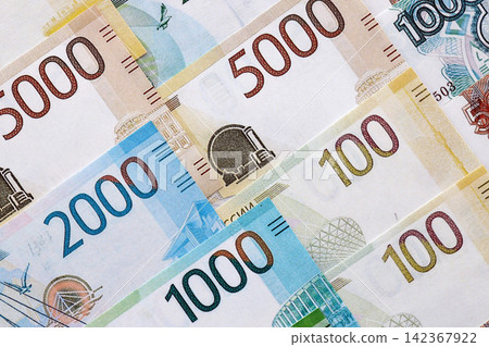 Russian ruble paper banknotes pile on table. Russia RUB currency money bills in big amount Russian ruble paper banknotes pile on table. Russia RUB currency money bills in big amount 142367922