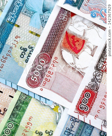 Myanmar kyat paper banknotes pile on table. Myanmar MMK currency money bills in big amount Myanmar kyat paper banknotes pile on table. Myanmar MMK currency money bills in big amount 142367929