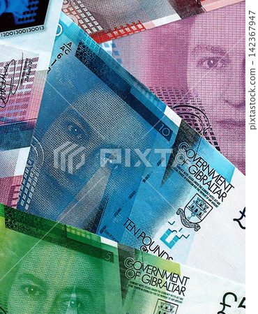 Gibraltar pound paper banknotes pile on table. Gibraltar GIP currency money bills in big amount Gibraltar pound paper banknotes pile on table. Gibraltar GIP currency money bills in big amount 142367947