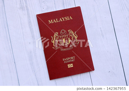 Malaysian passport on table. Official identification document book for citizens of Malaysia Malaysian passport on table. Official identification document book for citizens of Malaysia 142367955