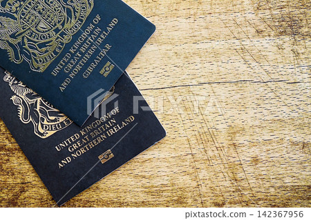 British and Gibraltar passports on table. Official identification document books for citizens of UK British and Gibraltar passports on table. Official identification document books for citizens of UK 142367956