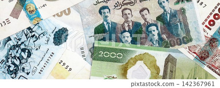 Algerian dinar paper banknotes pile on table. Algeria DZD currency money bills in big amount Algerian dinar paper banknotes pile on table. Algeria DZD currency money bills in big amount 142367961