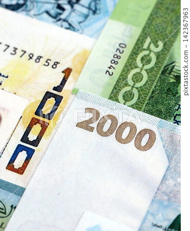 Algerian dinar paper banknotes pile on table. Algeria DZD currency money bills in big amount Algerian dinar paper banknotes pile on table. Algeria DZD currency money bills in big amount 142367963