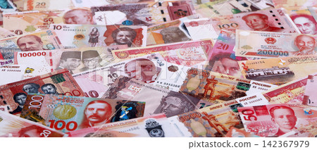 Various currencies money bills banknotes in red color. Many cash bills Various currencies money bills banknotes in red color. Many cash bills 142367979