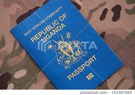 Ugandan passport on table close up. Official identification document book for citizens of Uganda Ugandan passport on table close up. Official identification document book for citizens of Uganda 142367984