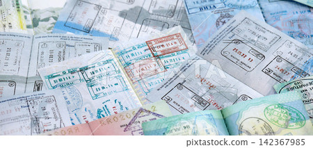 Big amount of passport pages full of colorful stamps after travel and border crossing 142367985