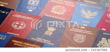 Big amount of passports of various different countries. Covers of expired passports close up Big amount of passports of various different countries. Covers of expired passports close up 142367986