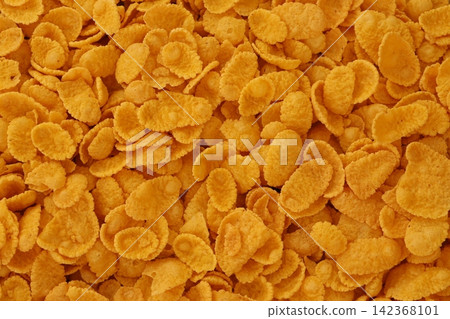 Corn flakes background and texture. Cornflake cereal box for morning breakfast Corn flakes background and texture. Cornflake cereal box for morning breakfast 142368101