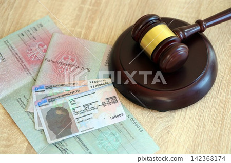 German temporary Permanent resident card lies with judge hammer. Aufenthaltstitel German temporary Permanent resident card lies with judge hammer. Aufenthaltstitel 142368174