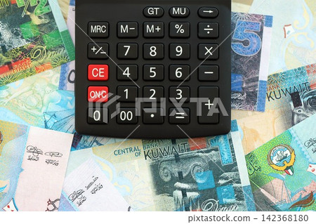 Kuwaiti dinar currency money bills and calculator. The concept of taxation and money count Kuwaiti dinar currency money bills and calculator. The concept of taxation and money count 142368180