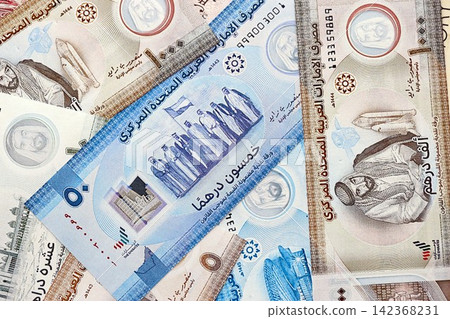 United Arab Emirates dirham currency money bills. The current banknotes lies on table in big amount United Arab Emirates dirham currency money bills. The current banknotes lies on table in big amount 142368231