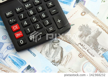 United Arab Emirates dirham currency money bills and calculator. The concept of taxation and money count 142368232