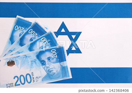 Israel New Shekels banknotes on national flag. The current Israel money bills lies on flag Israel New Shekels banknotes on national flag. The current Israel money bills lies on flag 142368406