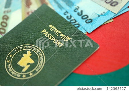 Bangladeshi taka money bills in big amount and passport lies on Bangladesh flag close up Bangladeshi taka money bills in big amount and passport lies on Bangladesh flag close up 142368527