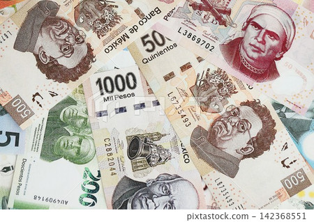 Mexican pesos money bills in big amount lies on white table close up Mexican pesos money bills in big amount lies on white table close up 142368551