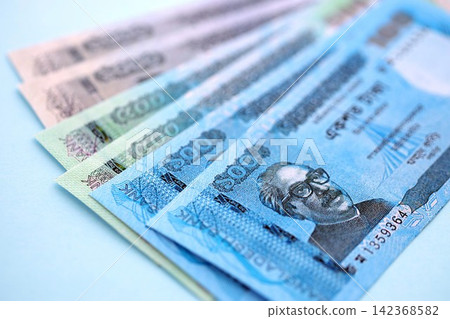Bangladeshi taka money bills in big amount lies on teal color table close up 142368582