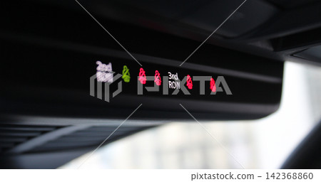 Seat belt fastening indicator sensors for the second and third row of seats in a family car. Passengers safety indicators on a roof panel in car Seat belt fastening indicator sensors for the second and third row of seats in a family car. Passengers safety indicators on a roof panel in car 142368860
