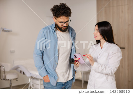 Dermatologist using smartphone dermatoscope for skin examination Dermatologist using smartphone dermatoscope for skin examination 142368910