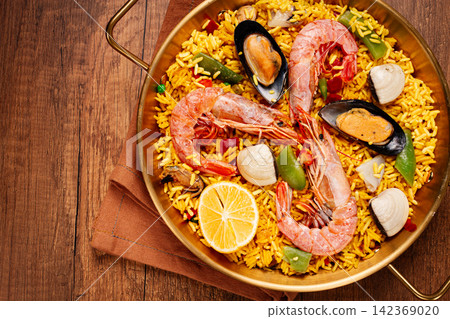 Seafood paella, in a frying pan, on a wooden table, no people, Seafood paella, in a frying pan, on a wooden table, no people, 142369020