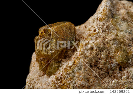 Macro stone Grossular mineral on a black background Macro stone Grossular mineral on a black background 142369261