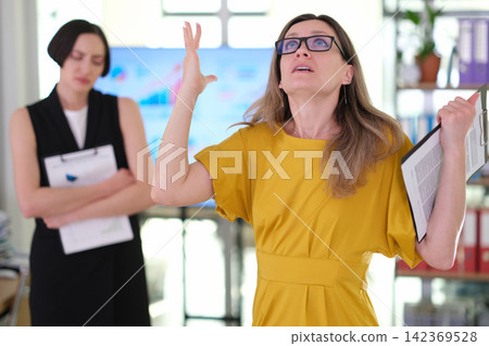 Frustrated businesswoman gestures during tense office meeting 142369528