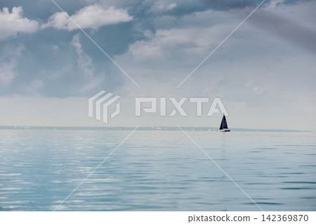 magic reflections on water surface, sailing regatta in the Gulf of Finland at sunny day, Yachtsmen are sitting amicably on board of the sailing boat, teamwork magic reflections on water surface, sailing regatta in the Gulf of Finland at sunny day, Yachtsmen are sitting amicably on board of the sailing boat, teamwork 142369870
