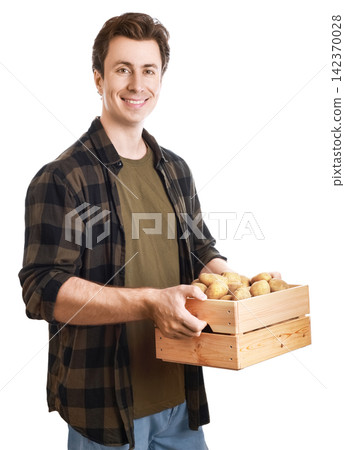Happy male farmer holding a wooden crate with fresh organic potato harvest. Local farming and sustainable agriculture concept isolated on white Happy male farmer holding a wooden crate with fresh organic potato harvest. Local farming and sustainable agriculture concept isolated on white 142370028