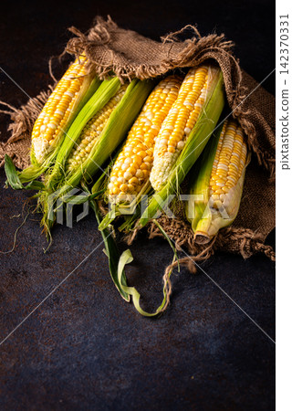 Raw uncooked fresh corn. Healthy food Raw uncooked fresh corn. Healthy food 142370331