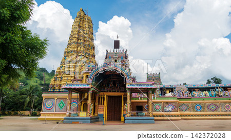 Colorful Hindu Temple Gopuram Under Dramatic Cloudy Sky Colorful Hindu Temple Gopuram Under Dramatic Cloudy Sky 142372028
