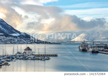 Arctic Harbor with Snowy Mountains and Dramatic Winter Sky Arctic Harbor with Snowy Mountains and Dramatic Winter Sky 142372064