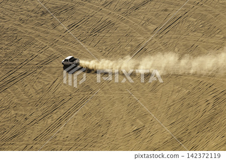 Aerial Desert Off-Road Truck Driving Through Sand Dunes Aerial Desert Off-Road Truck Driving Through Sand Dunes 142372119