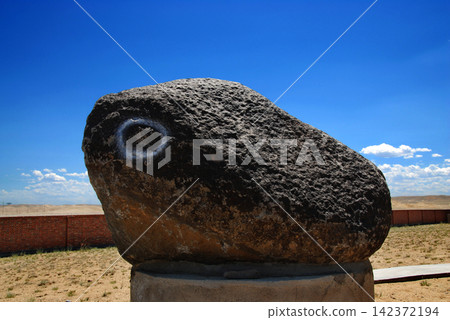 Large Meteorite Rock in Desert Landscape Under Blue Sky Large Meteorite Rock in Desert Landscape Under Blue Sky 142372194