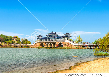 Chinese Pavilion Bridge Over Scenic Lake in Traditional Park Chinese Pavilion Bridge Over Scenic Lake in Traditional Park 142372235