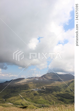 A breathtaking view of Senrigahama, a sandy beach of black volcanic ash near the Nakadake crater of Mount Aso in Kumamoto Prefecture, against a clear blue sky. A breathtaking view of Senrigahama, a sandy beach of black volcanic ash near the Nakadake crater of Mount Aso in Kumamoto Prefecture, against a clear blue sky. 142373395