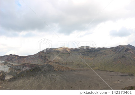 A breathtaking view of Senrigahama, a sandy beach of black volcanic ash near the Nakadake crater of Mount Aso in Kumamoto Prefecture, against a clear blue sky. A breathtaking view of Senrigahama, a sandy beach of black volcanic ash near the Nakadake crater of Mount Aso in Kumamoto Prefecture, against a clear blue sky. 142373401