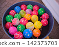 Colorful yo-yo balloons, a staple of summer festivals, float on the water in this event scene. 142373703