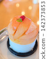 A refreshing fruit dessert beautifully garnished with thinly sliced peaches. 142373853