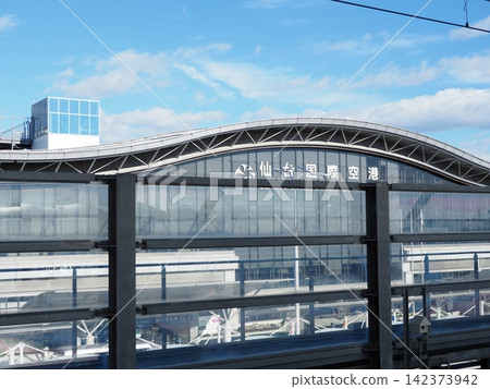The terminal building of Sendai International Airport stands under a blue sky. The terminal building of Sendai International Airport stands under a blue sky. 142373942